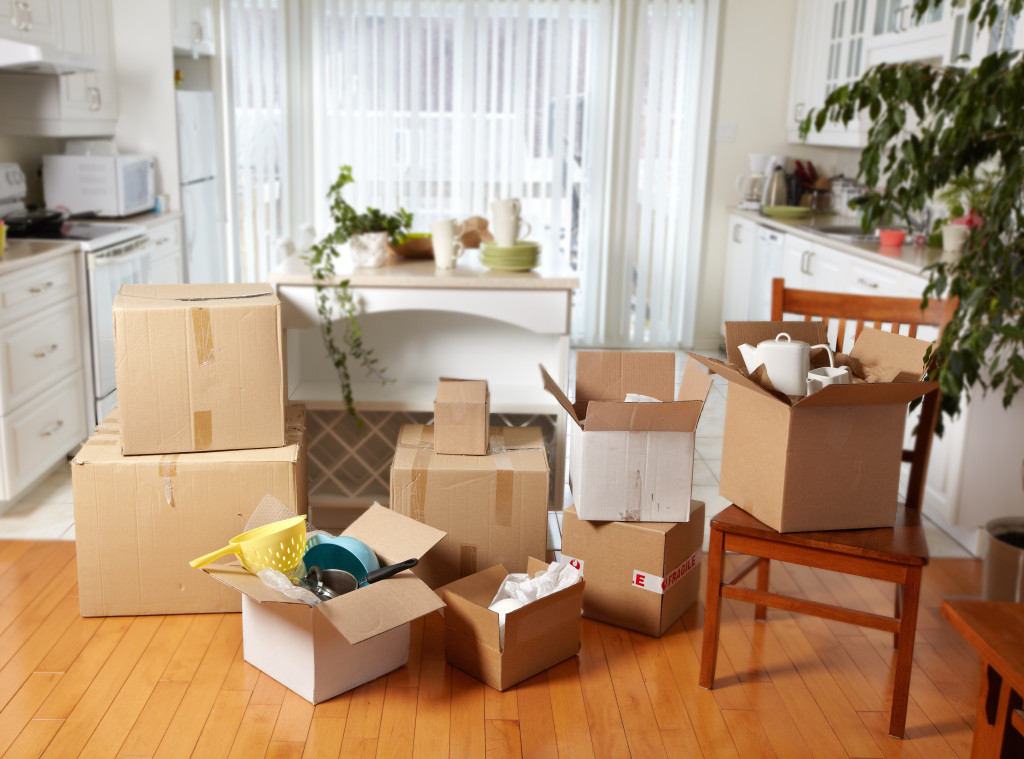 Moving boxes in new house. New apartment background.